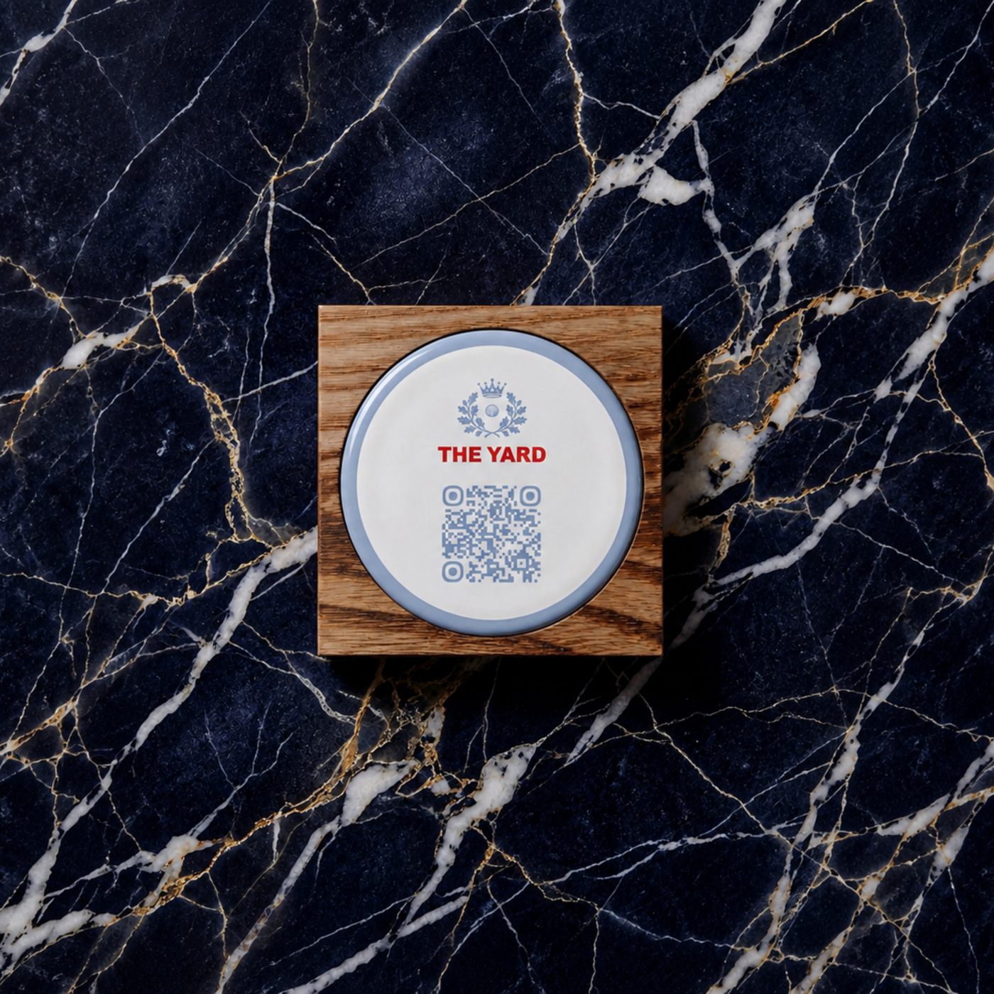 Round QR code touchpoint on a wooden plaque against dark marble.